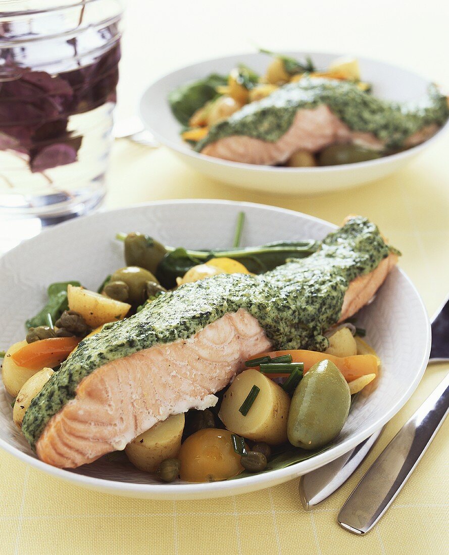 Salmon fillet with spinach sauce on potato salad