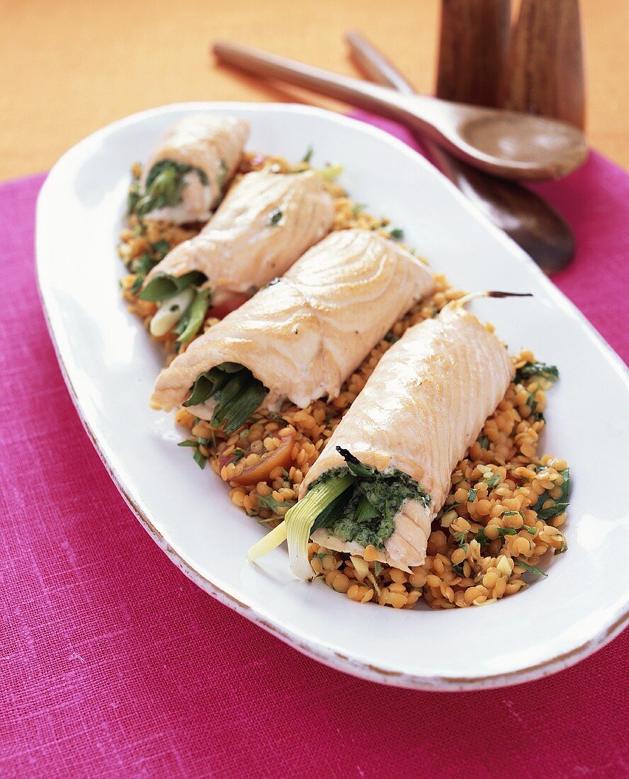Salmon roulades with spinach filling on lentil salad