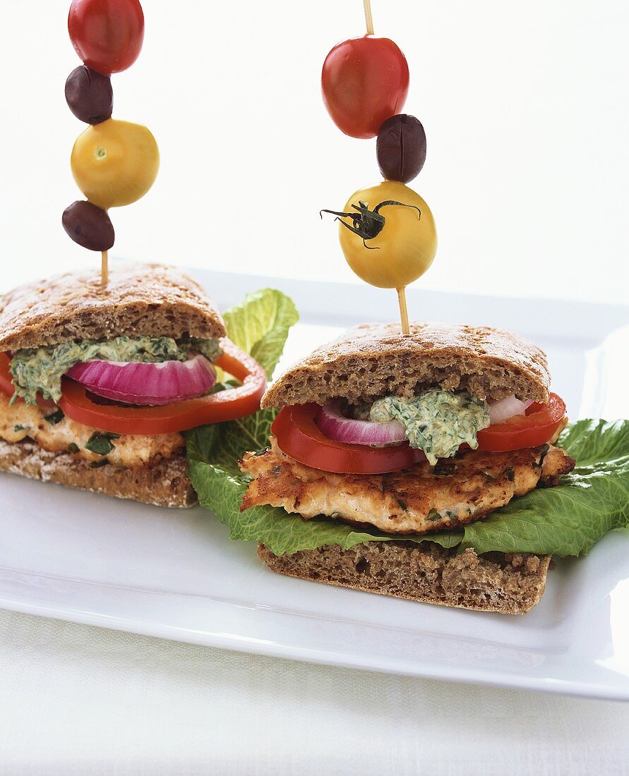 Salmon sandwiches with caper sauce and skewered vegetables