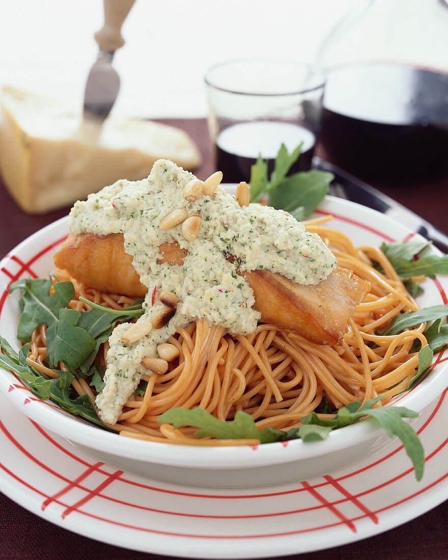 Red spaghetti with salmon and pine nuts