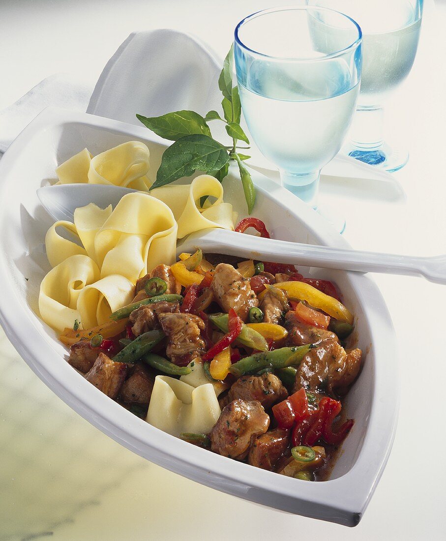 Spicy pork and pepper ragout with ribbon pasta