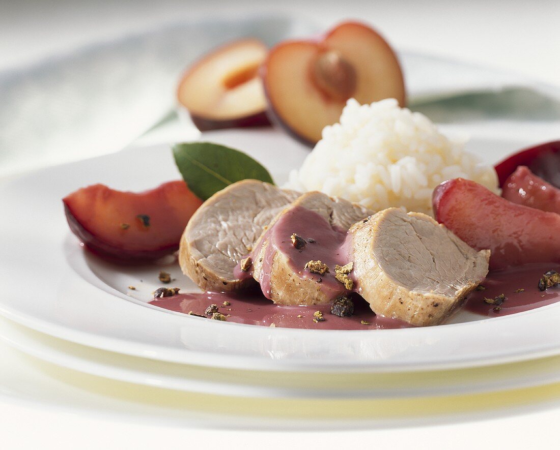 Pork fillet in juniper sauce with plums and rice