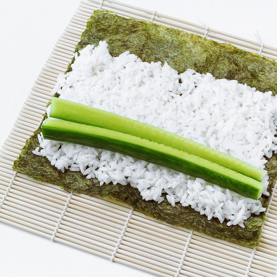 Making maki sushi with cucumber