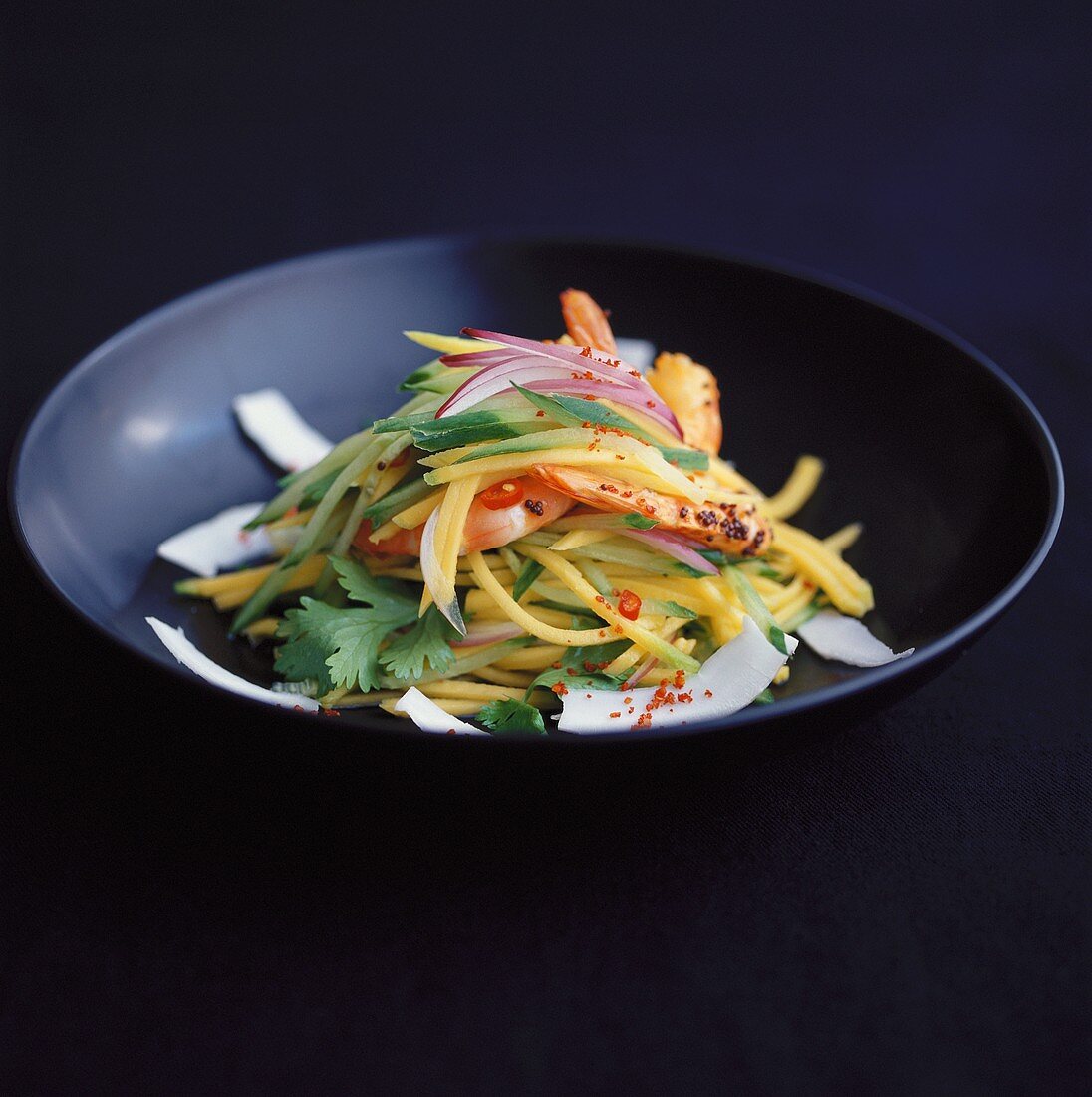 Papaya salad with coconut, onions and chilli rings