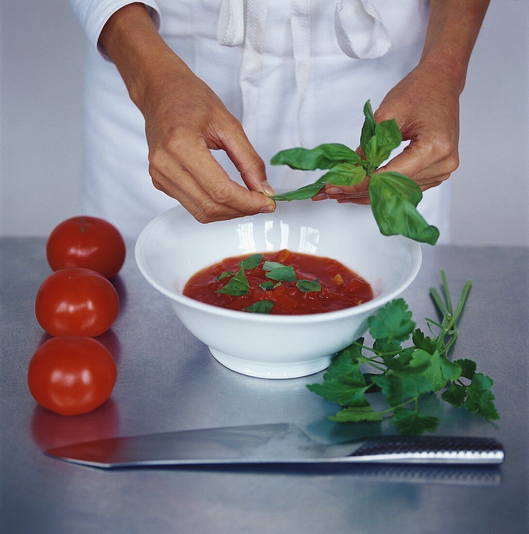 Making tomato sauce with basil