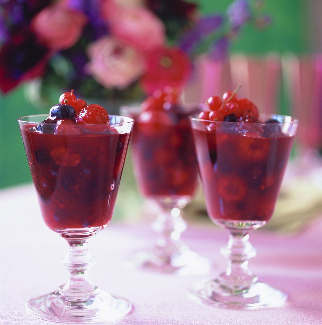 Berry compote in three glasses on table in the open air