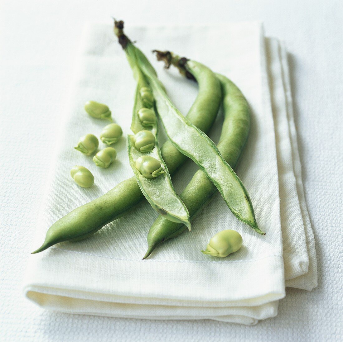 Broad beans, one pod opened