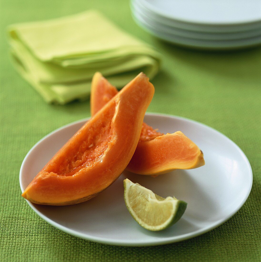 Two papaya wedges on a plate