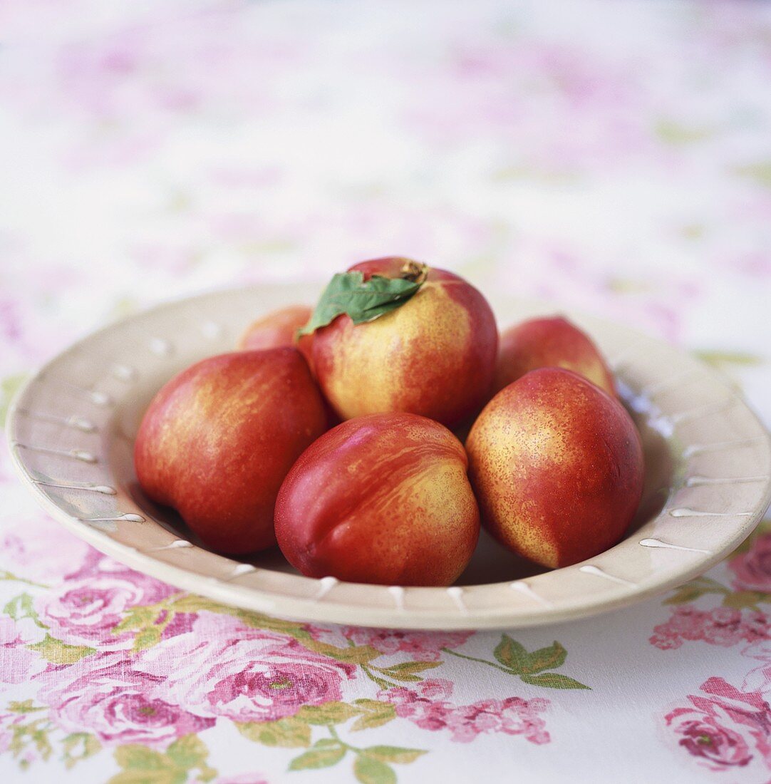 Several nectarines in a dish