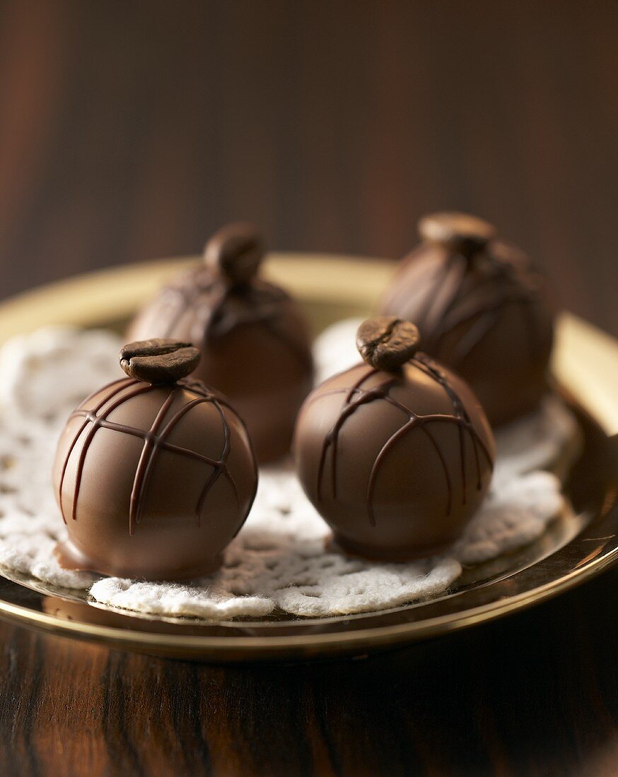 Coffee truffles with mocha beans on plate