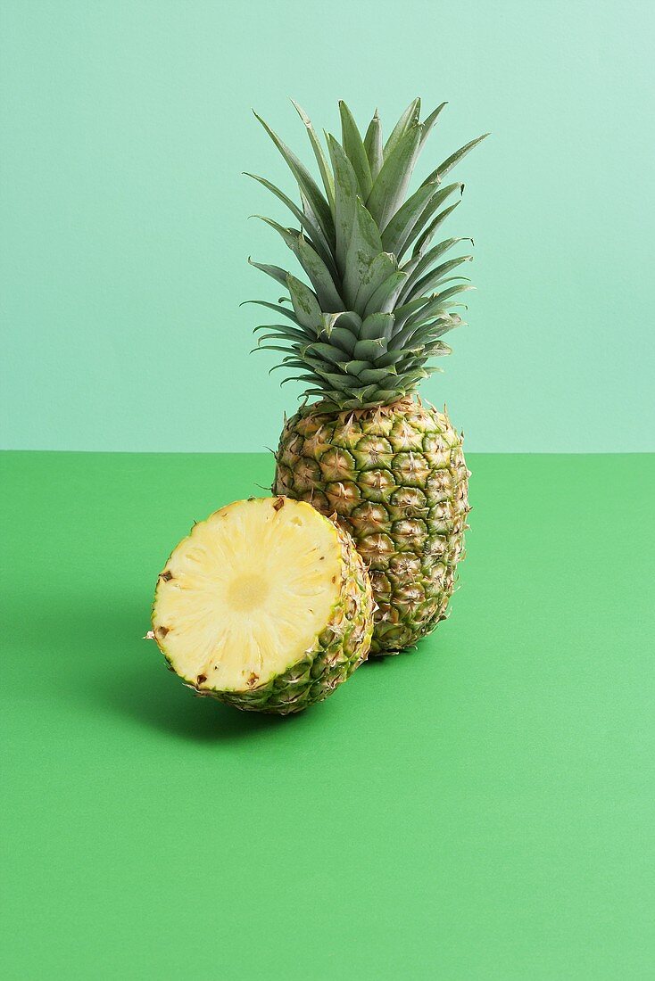 Whole pineapple and half a pineapple