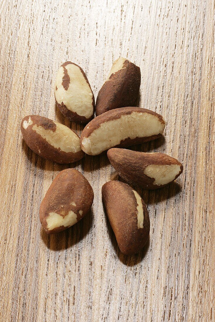 Several Brazil nuts on wooden background