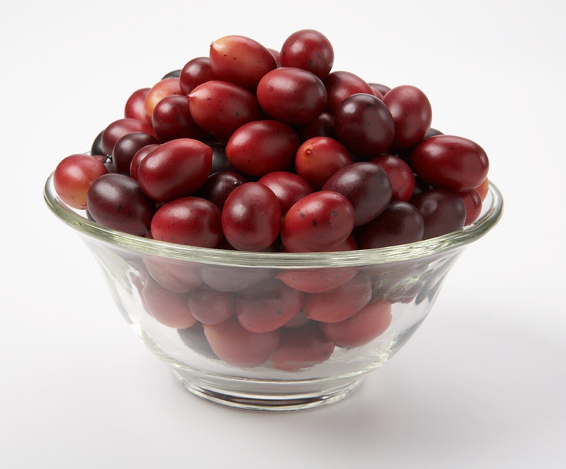 Artificial cranberries in a glass dish