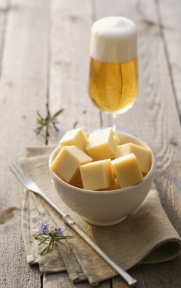 Diced cheese and a glass of beer
