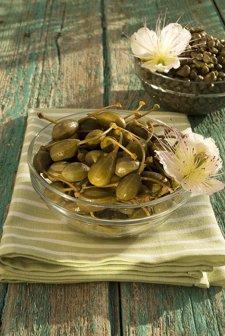 Capers with flowers in glass bowls