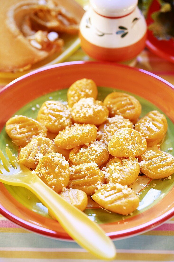 Pumpkin gnocchi, sprinkled with cheese, for children