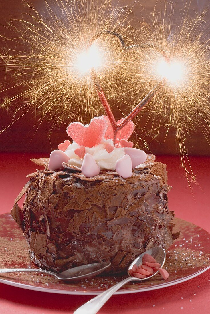 Chocolate cake decorated with sweets and sparkler