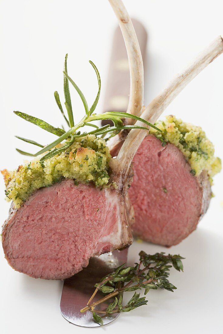 Lamb chops with herb crust on knife