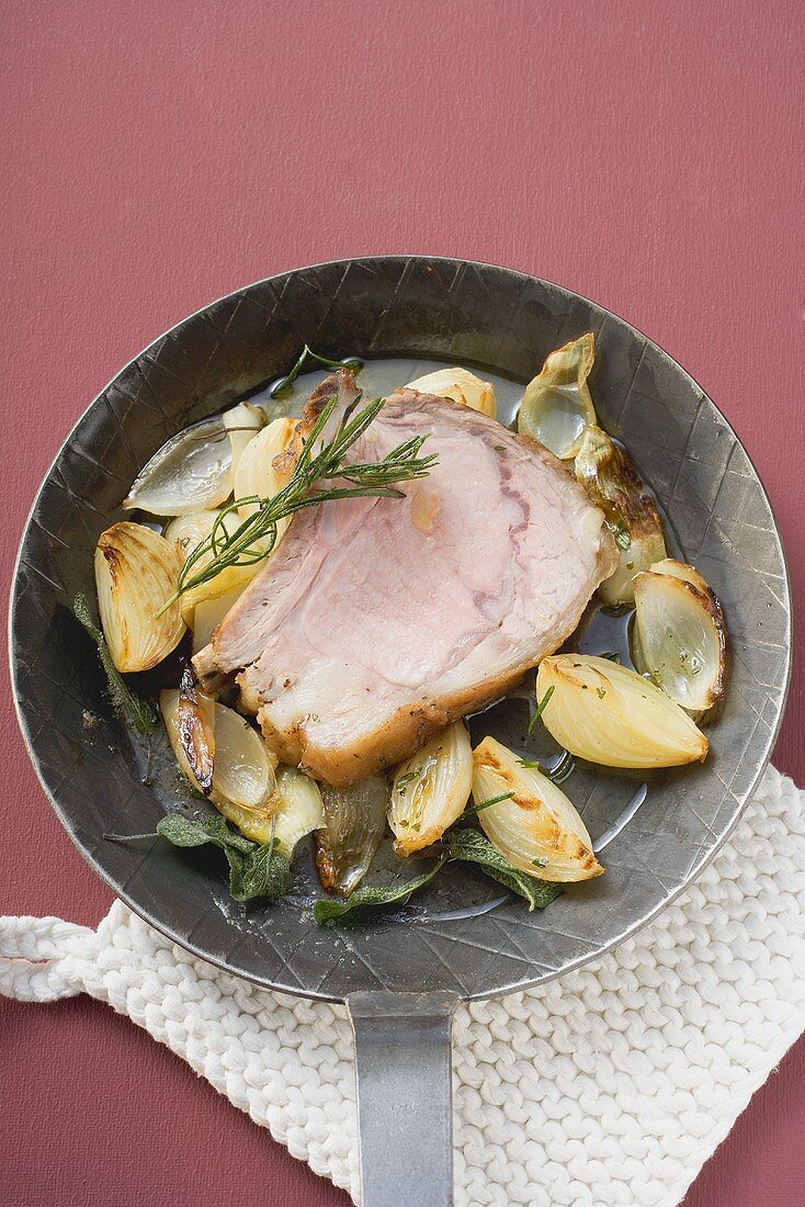 Fried veal loin steak and onions in frying pan