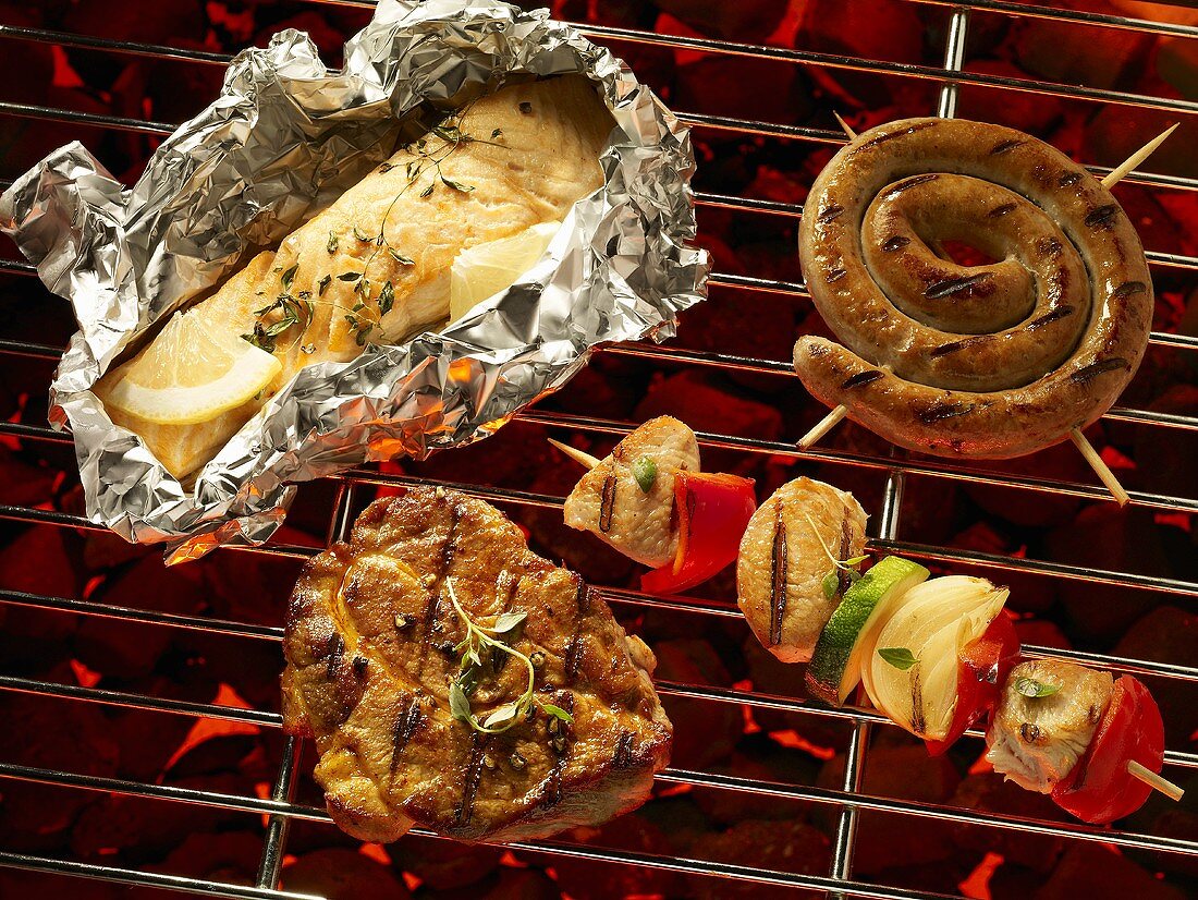 Fish in foil, meat, sausage and kebab on a barbecue