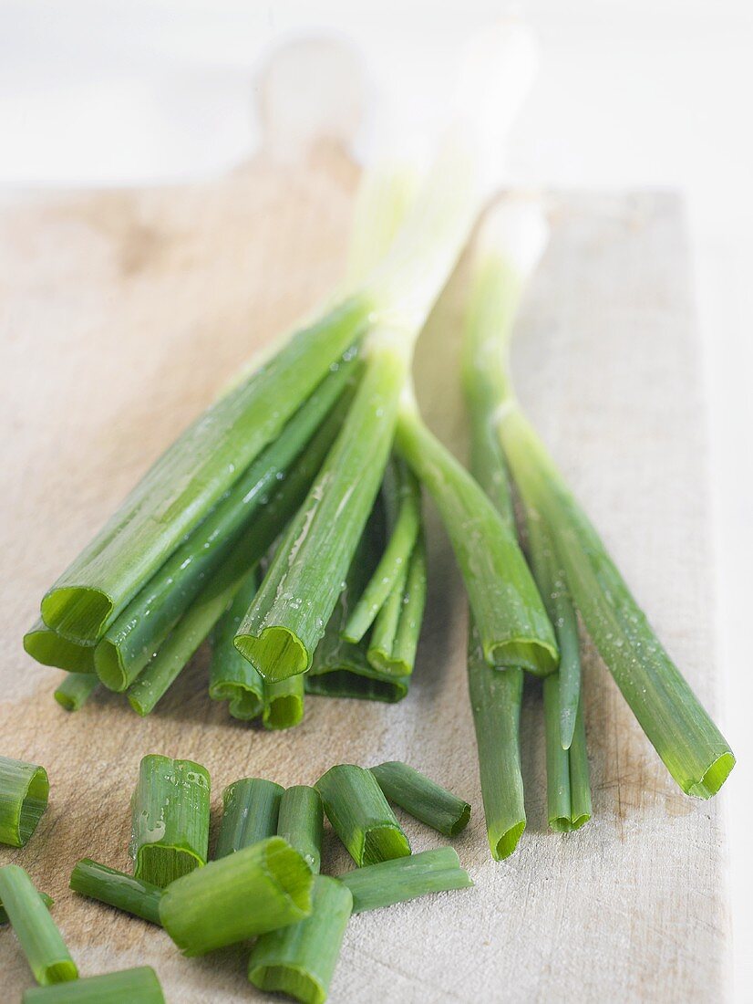 Spring onions on chopping board