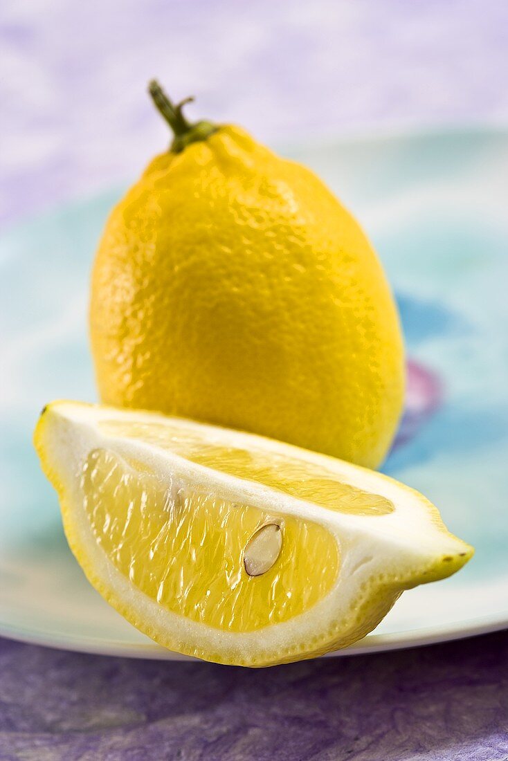 Whole lemon and lemon wedge