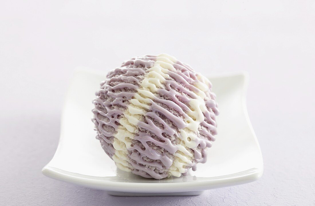 A scoop of lavender ice cream on plate