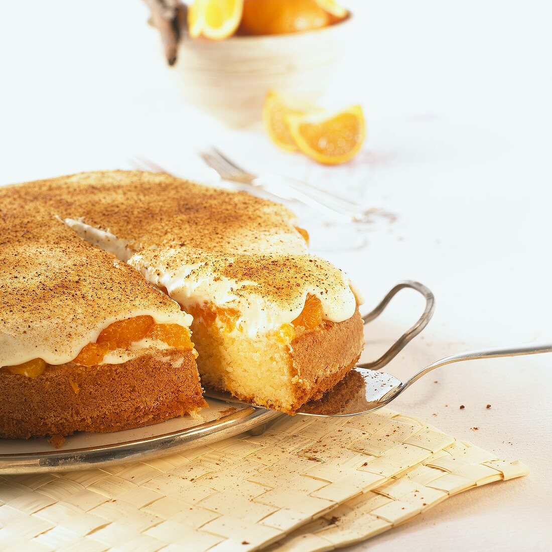 Mandarin orange cake with cinnamon, a piece partly removed