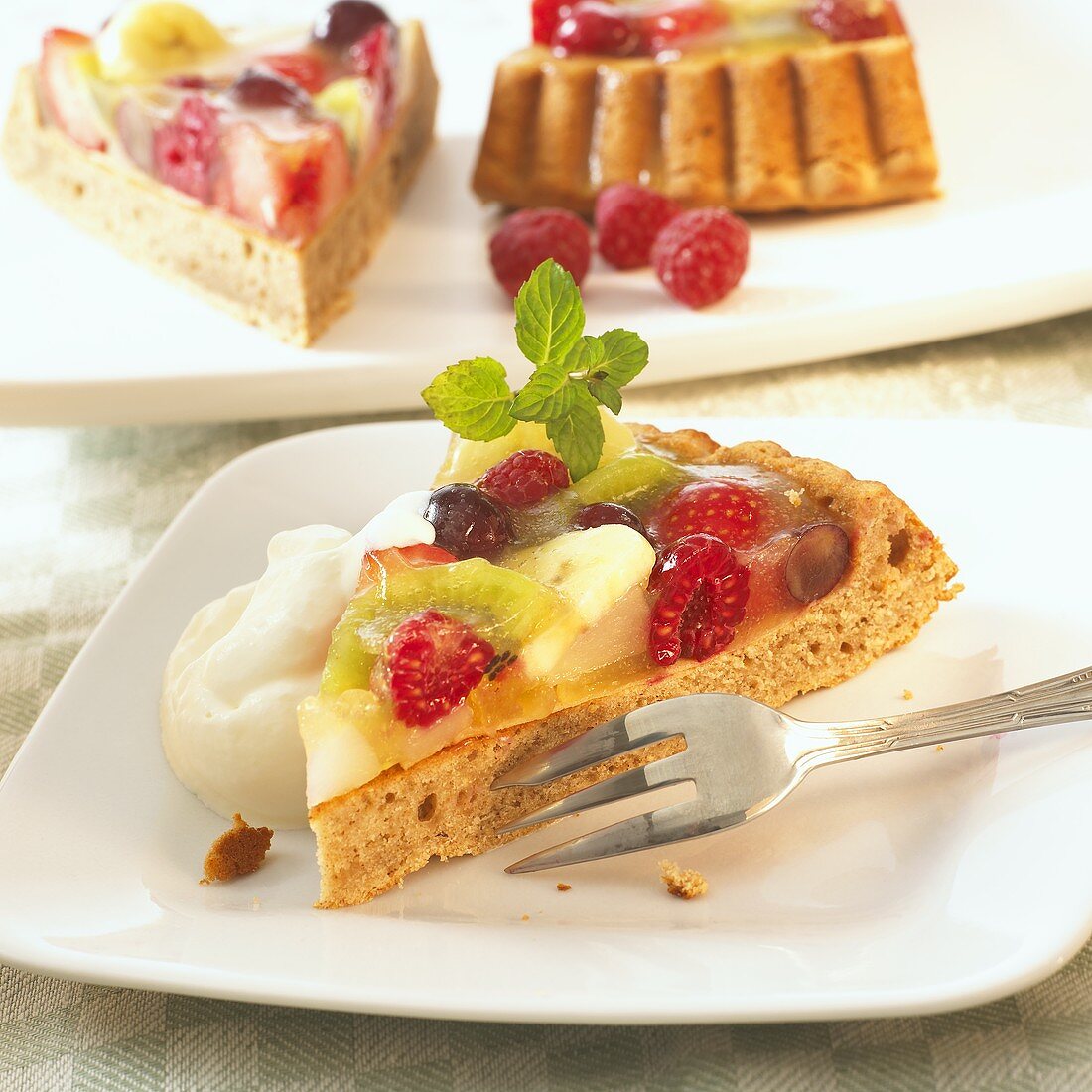 Three pieces of fruit flan with cream