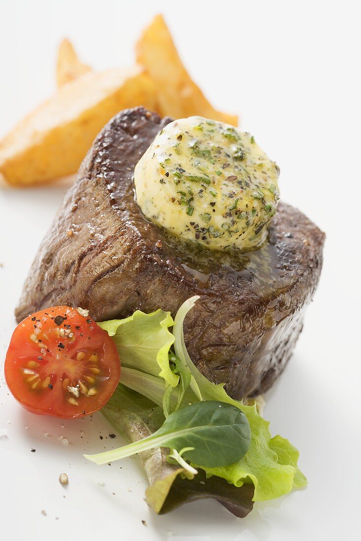 Beef fillet steak with herb butter and accompaniments