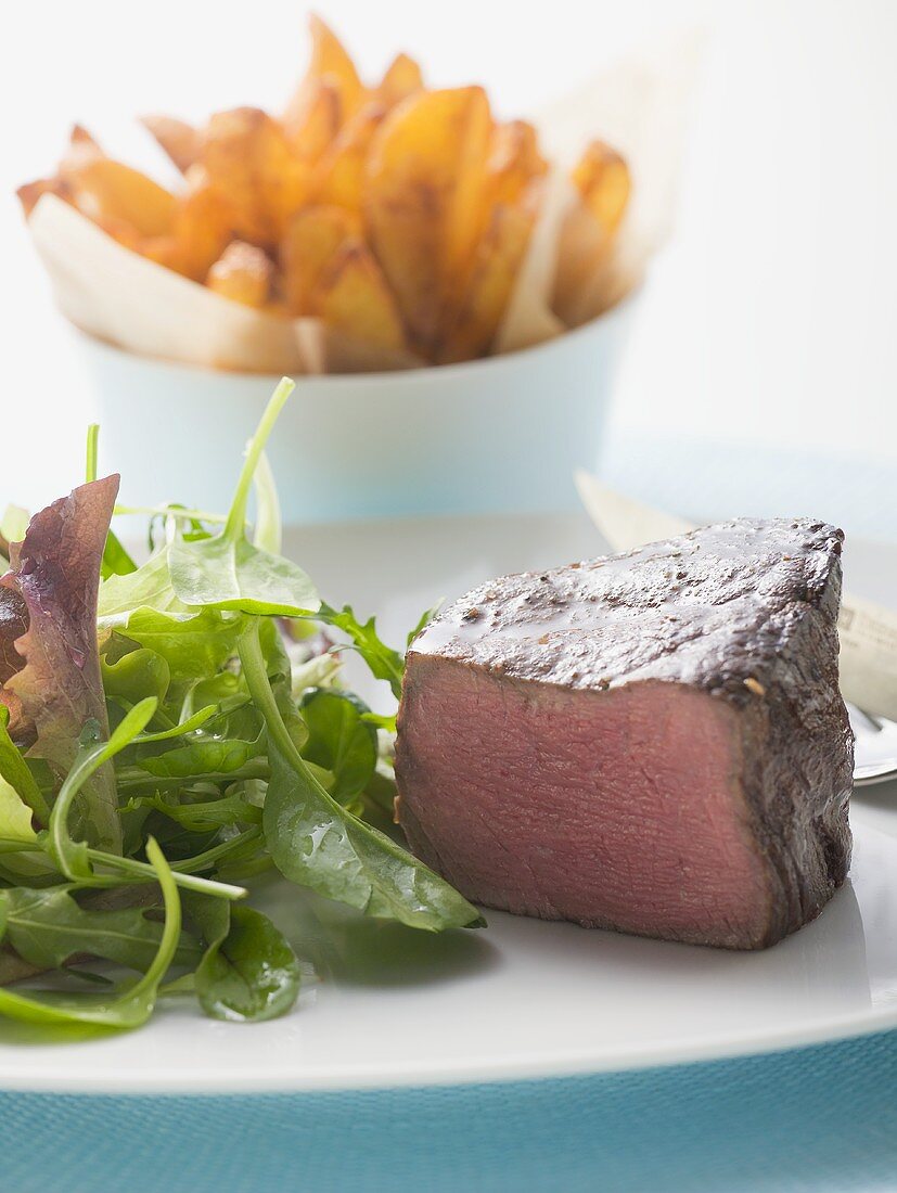 Beef fillet, a piece cut off, with salad & potato wedges
