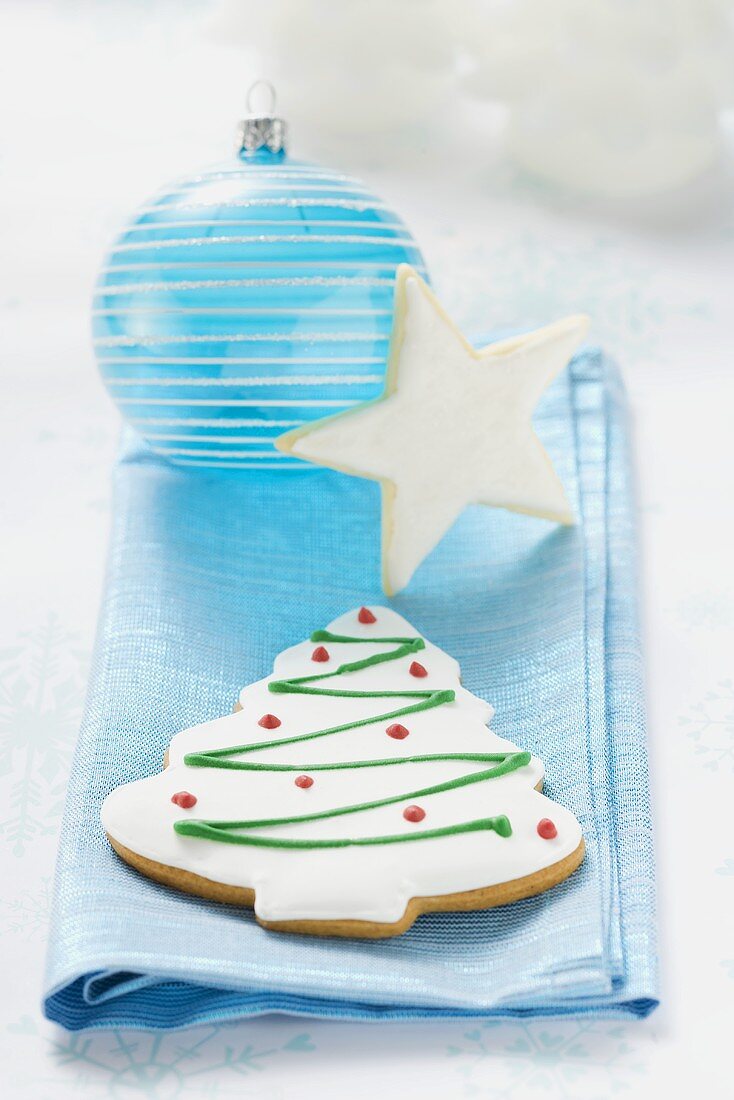 Christmas biscuits and Christmas bauble on blue cloth