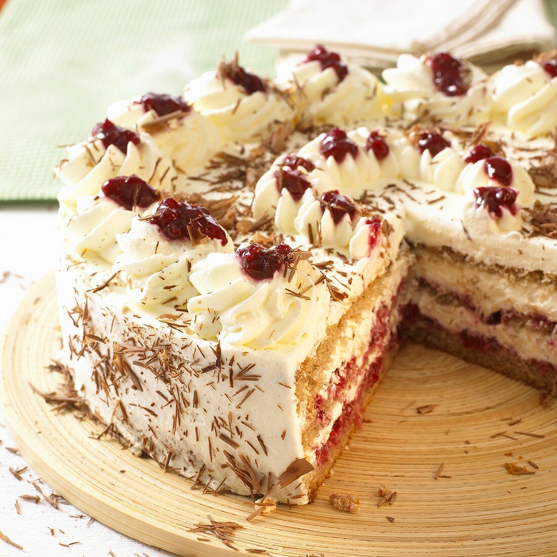 Buckwheat cake with cream and cherries, a piece removed