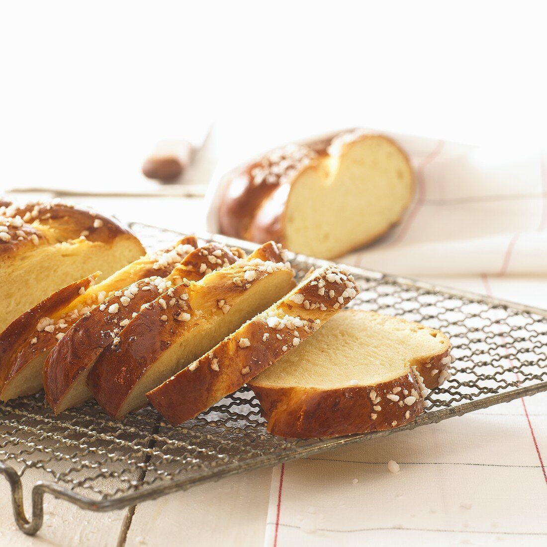 Yeast plait, partly sliced, on cake rack