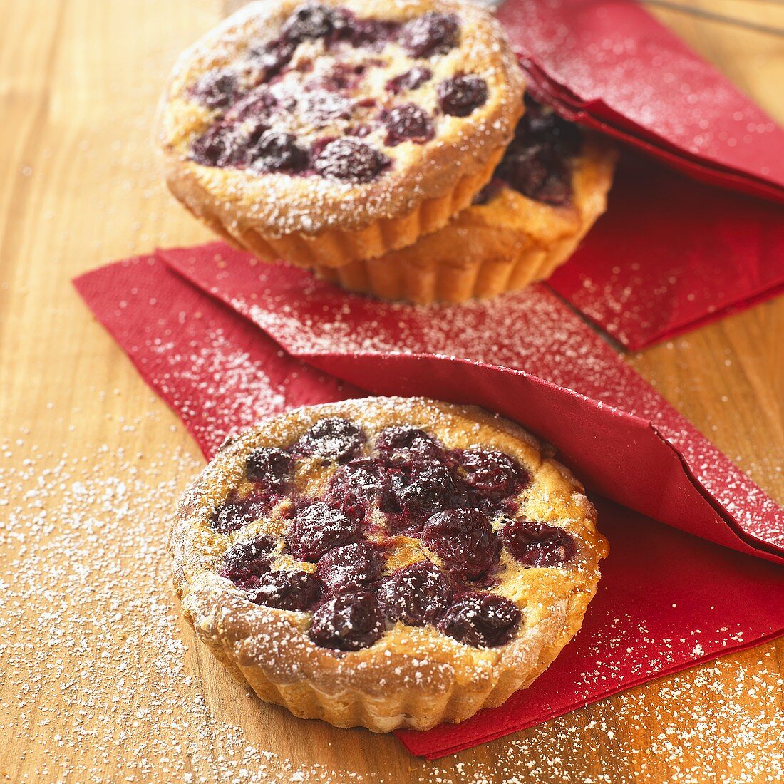 Cherry tarts dusted with icing sugar