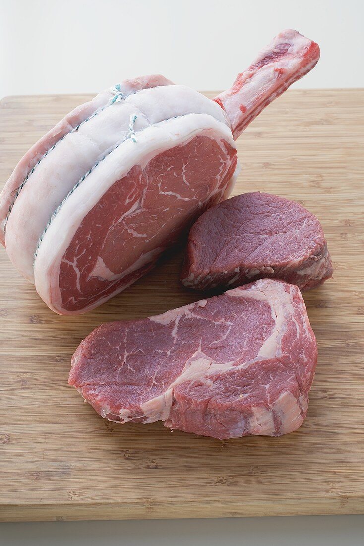 Various cuts of beef on chopping board