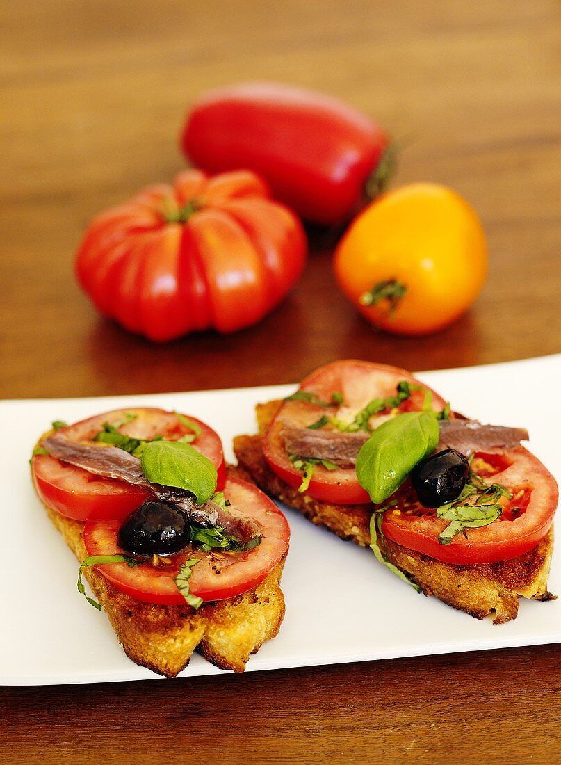 Crostini rustici (Tomatoes, olives and anchovies on toast)
