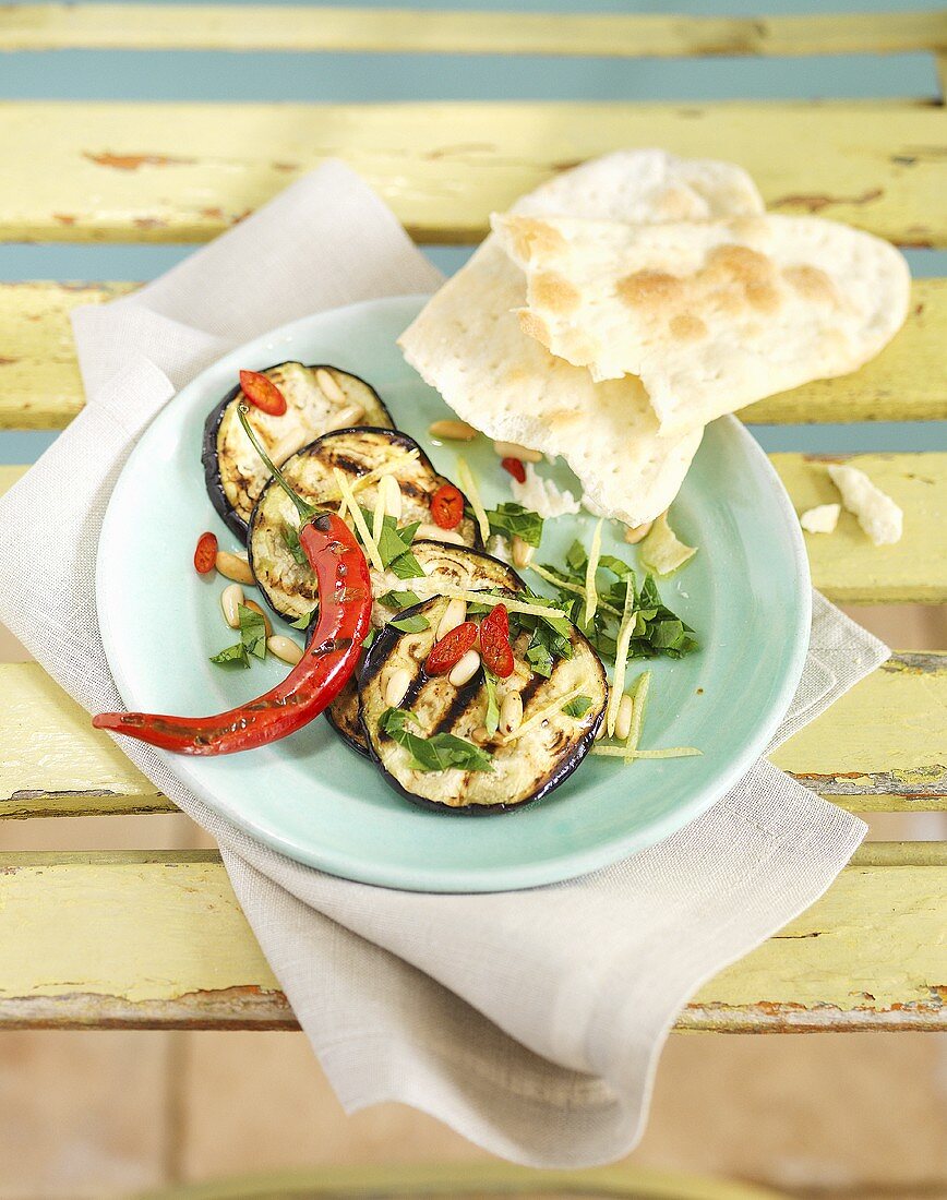Grilled aubergine slices with chillies and flatbread