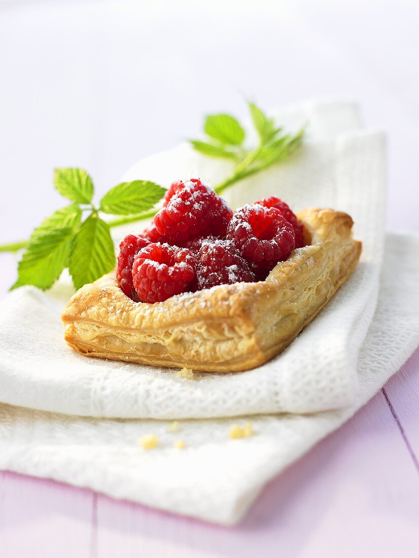 Raspberry puff pastry tart with icing sugar