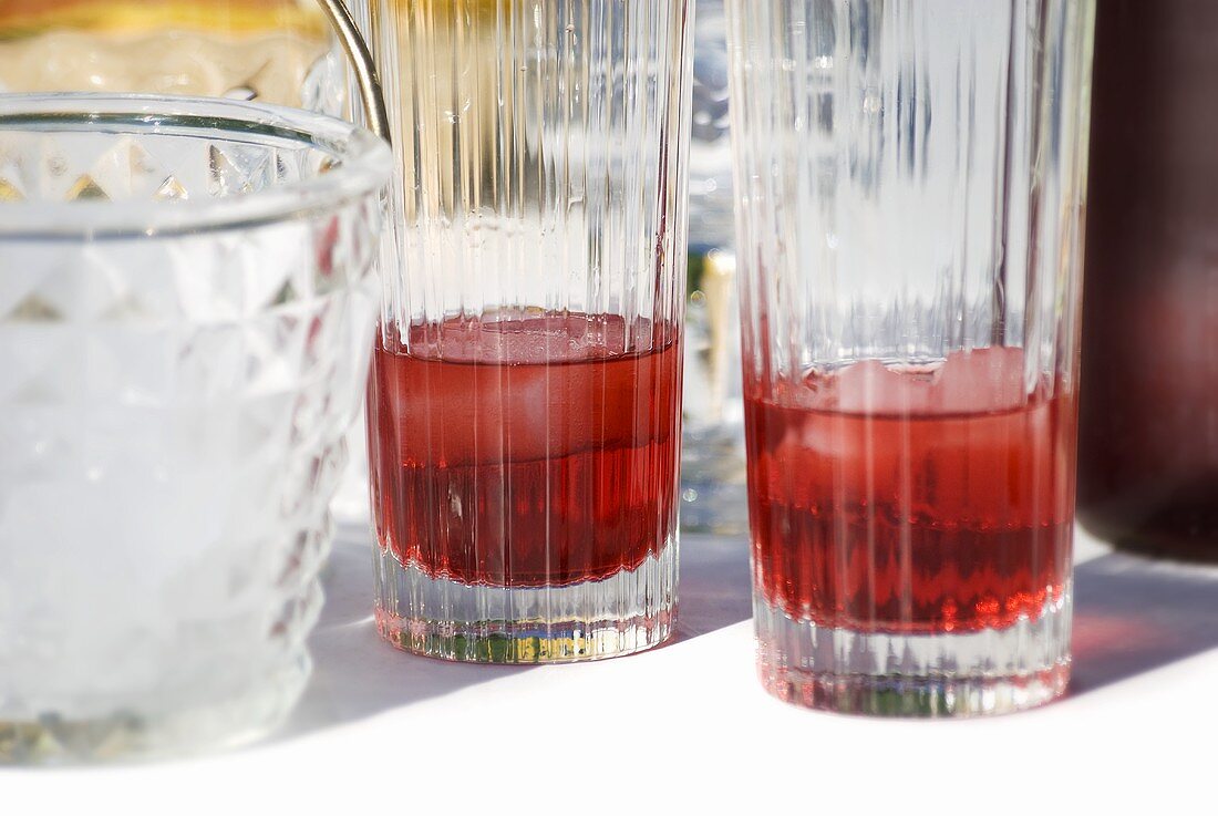 Two glasses of Campari with ice cubes