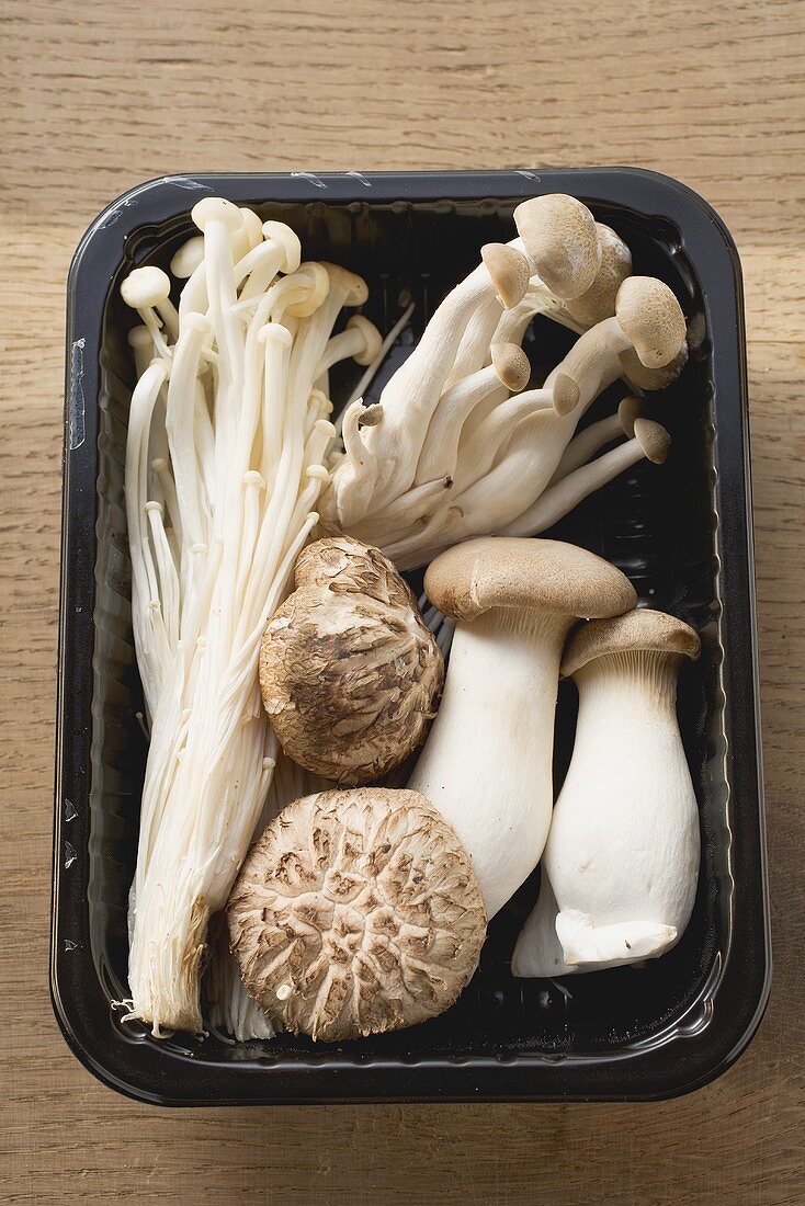 Assorted mushrooms in plastic tray