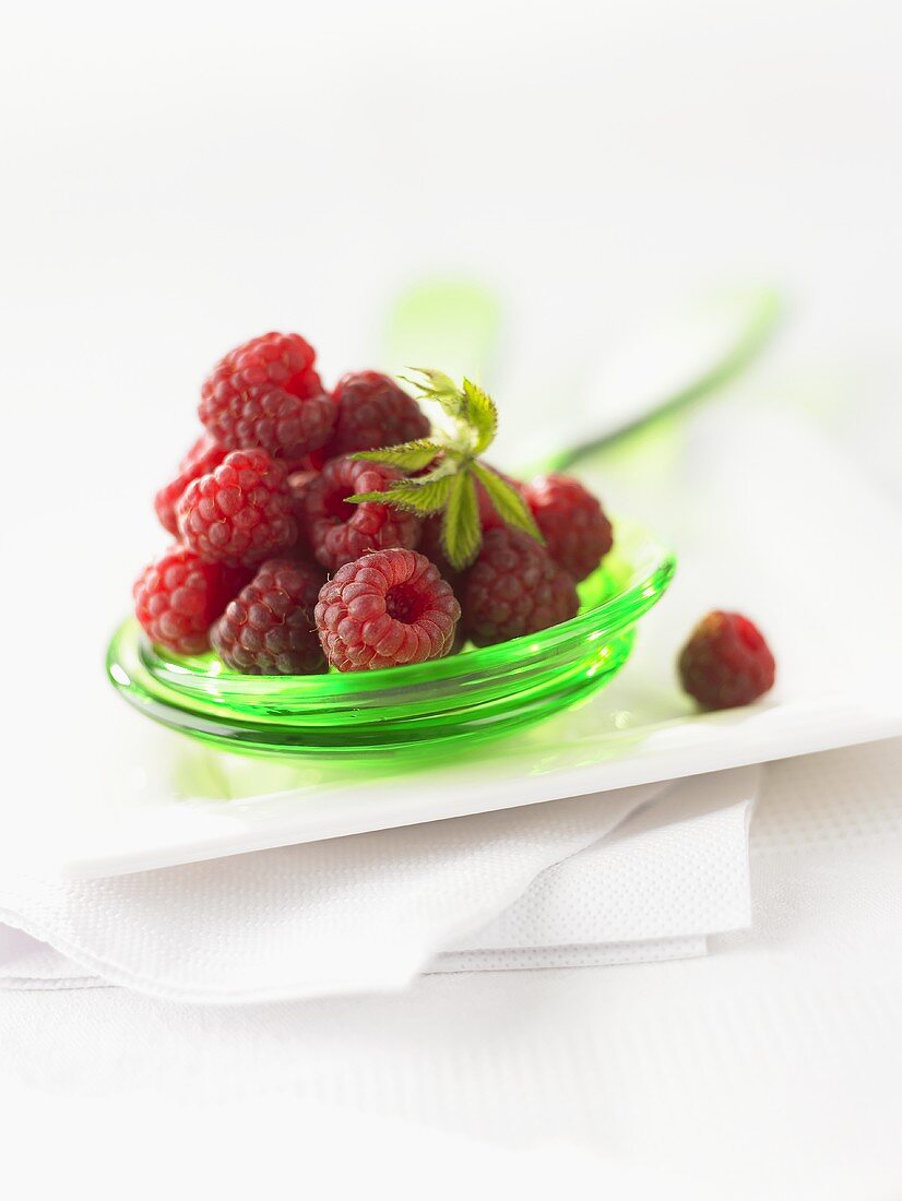 Fresh raspberries on salad servers
