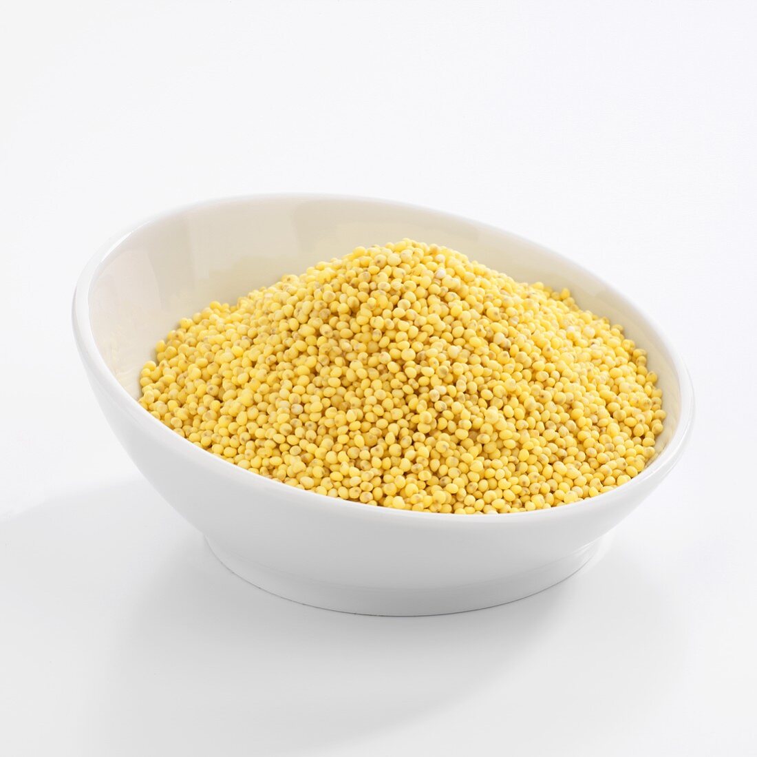 Organic golden millet in white bowl