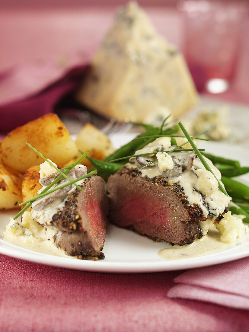 Peppered steak with Stilton and roast potatoes