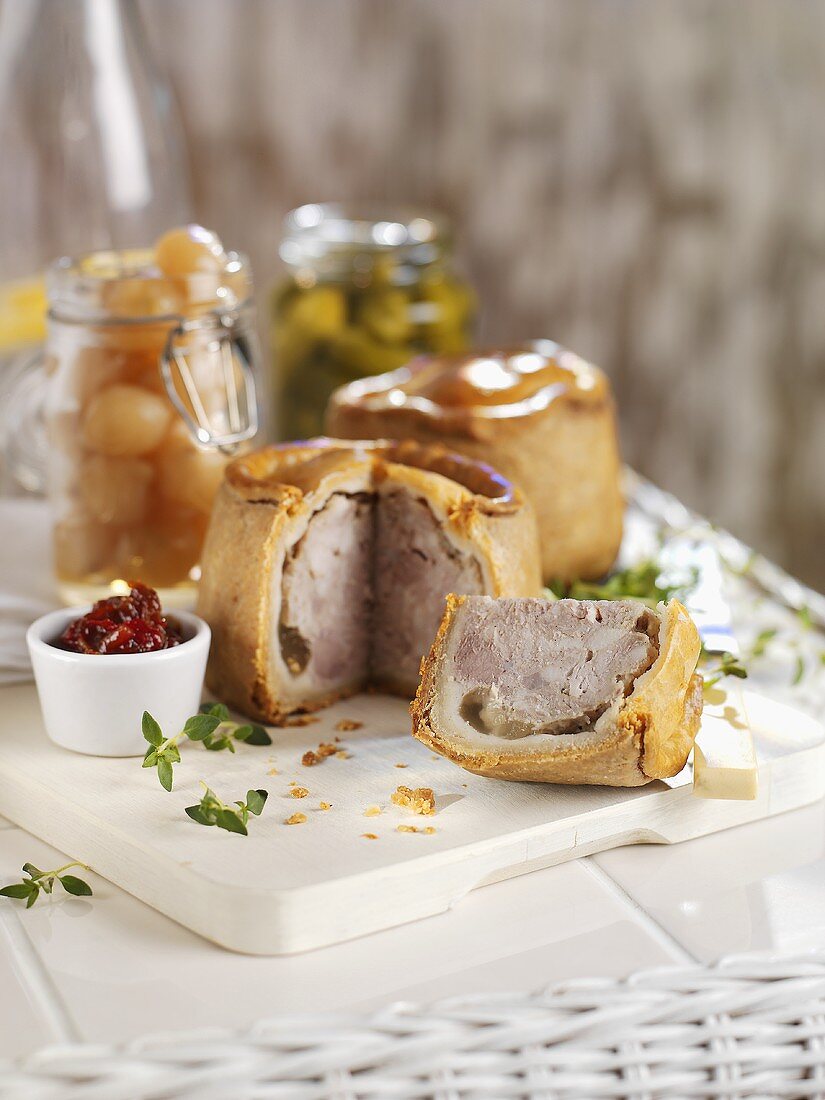 Pork pies with pickled onions and gherkins