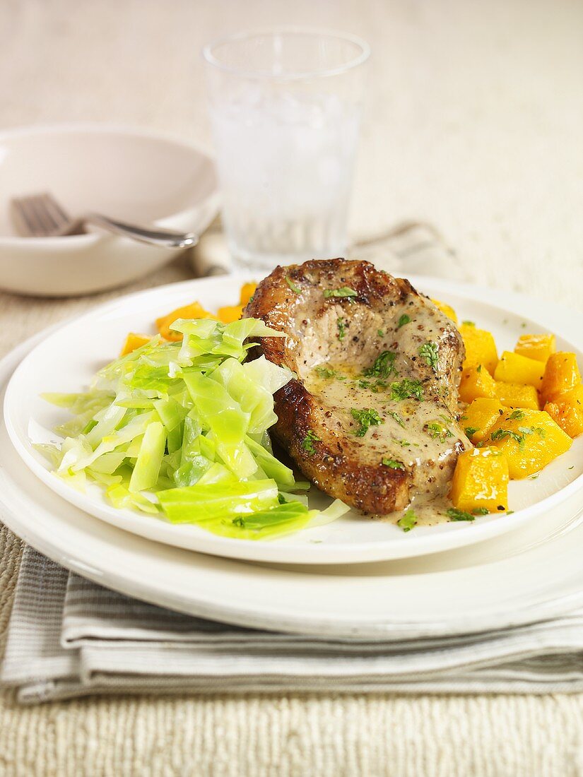 Pork chop with herb butter and vegetables
