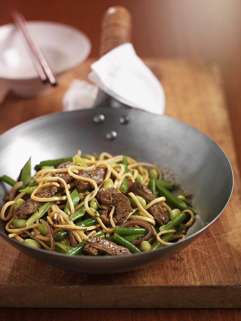 Stir-fried beef, vegetables and noodles in a wok