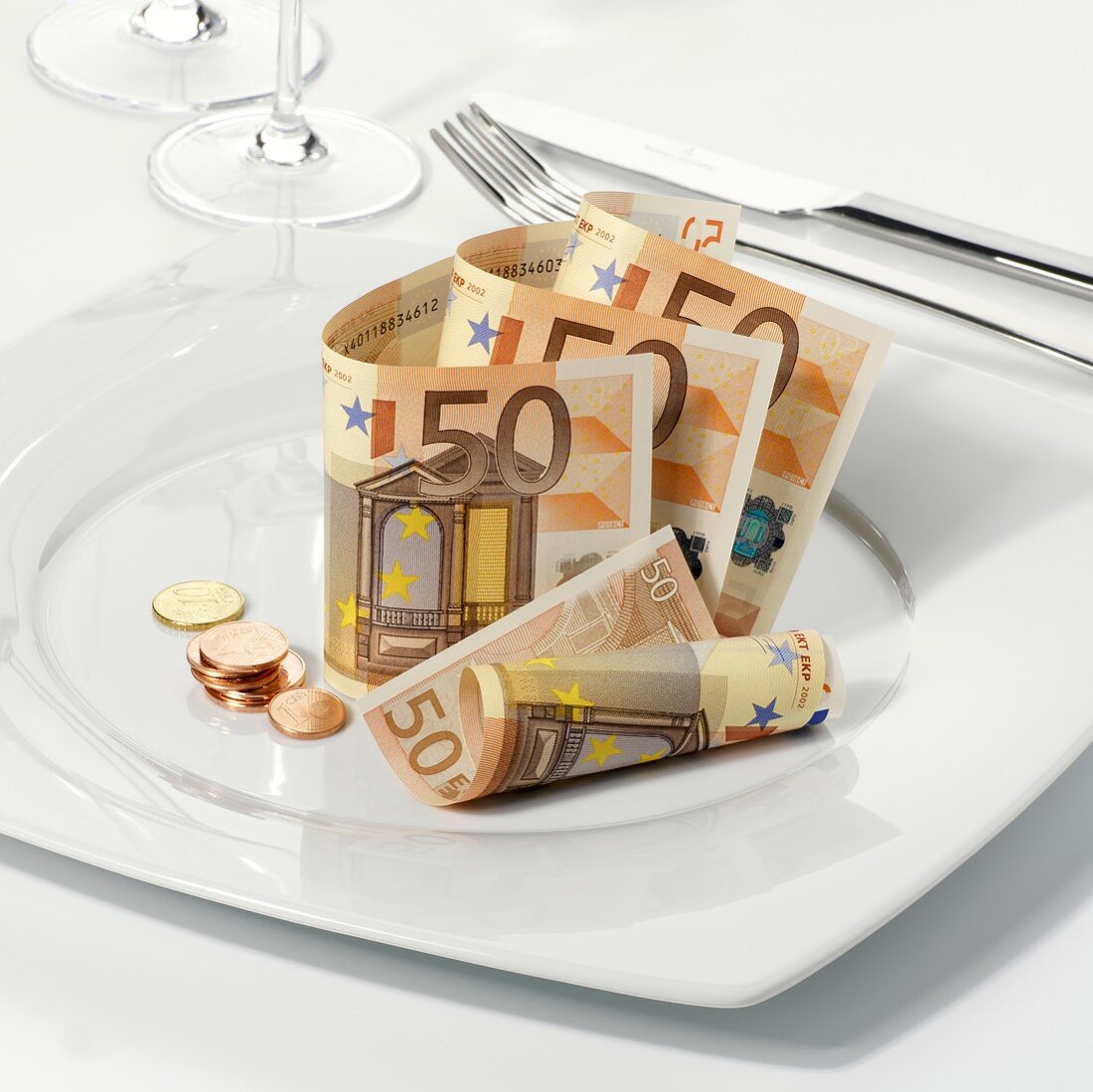 Euro notes and coins on plate