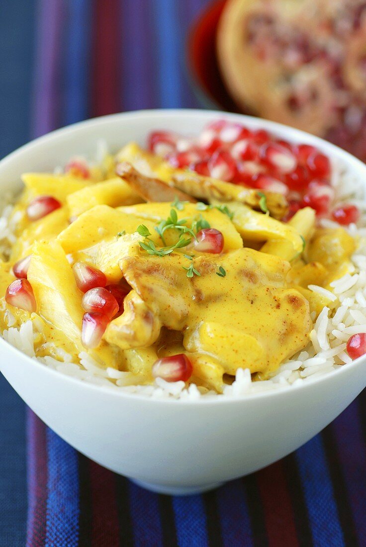Chicken curry with pomegranate seeds and rice