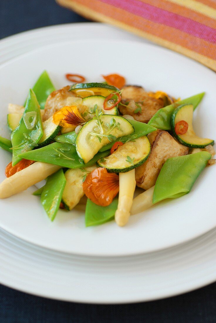 Mixed vegetable salad with chicken and edible flowers